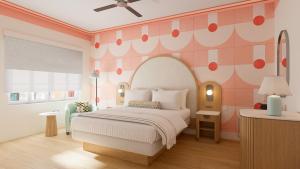 a bedroom with a bed and a pink wall at Waldorf Towers South Beach in Miami Beach