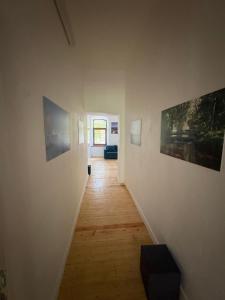 a hallway with paintings on the walls of a room at Ravelin Border Apartments in Narva
