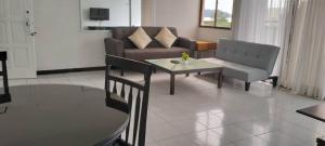 a living room with a couch and a table at sri sayang apartment in Batu Ferringhi