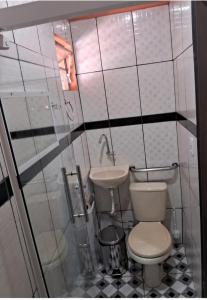 a small bathroom with a toilet and a sink at Hospedagem Aconchego do Lar in Barreirinhas
