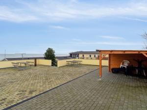 a patio with picnic tables and a pavilion at Apartment Henna - 50m from the sea by Interhome in Allinge