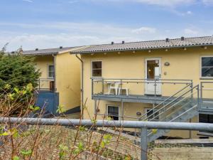 a yellow house with a staircase in front of it at Apartment Henna - 50m from the sea by Interhome in Allinge
