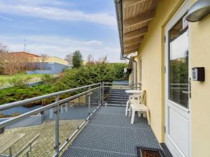 a balcony with stairs and chairs on a house at Apartment Henna - 50m from the sea by Interhome in Allinge +16 photos