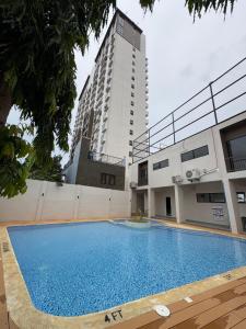 a large swimming pool in front of a building at Chic Condo with Gym and Pool Access in Mactan
