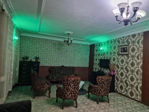 a living room with green lights on the walls at Complexe la samaritaine 1 in Yaoundé +2 photos
