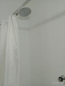 a shower with a curtain and a shower head at house city in Mar del Plata +22 photos