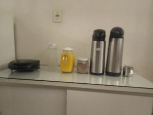 a counter with two bottles and a phone on it at Hotel Hilton in Juiz de Fora