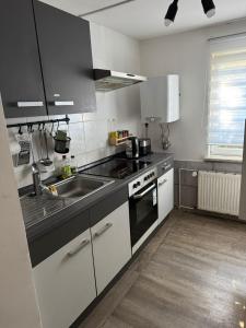 a kitchen with a sink and a stove top oven at Monteurswohnung Rothentor4 in Steffin