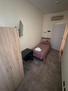 a small bedroom with a bed and a table at Residence H5 in Piacenza +8 photos