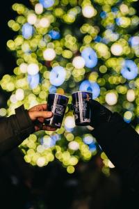 a person holding up two cups of coffee at AC Hotel by Marriott Strasbourg in Strasbourg