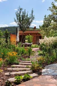 a garden with a stone path in front of a house at Apartmán Rezidence Malá Louka in Kublov +2 photos