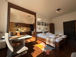a bedroom with a bed and a desk and a table at L69 Apartments - Angel's Apartment in Banská Bystrica
