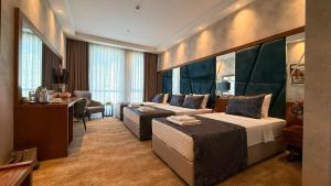a hotel room with a bed and a desk at Alsancak Prime Hotel Konya in Yazır +53 photos