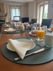 una mesa con platos y servilletas en la parte superior en Le colibri bleu, en Argeliers