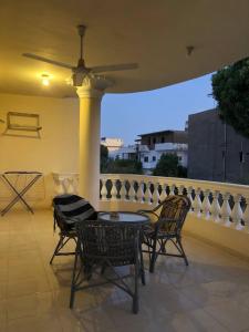 a patio with a table and chairs on a balcony at Ozera villa - west bank in Luxor