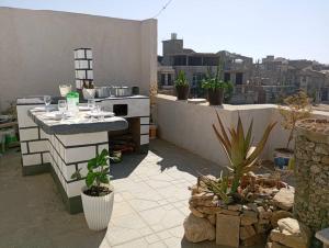 a rooftop patio with a table and some plants at Lemlem Studio 