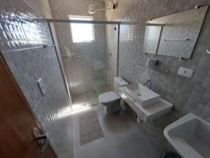 a bathroom with a shower and a toilet and a sink at Suítes XIBAYKA in Ilhabela +135 photos
