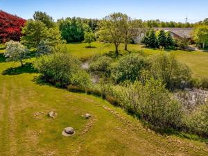 an aerial view of a field with a pond at Holiday Home Elia - 5km to the fjord by Interhome in Spottrup