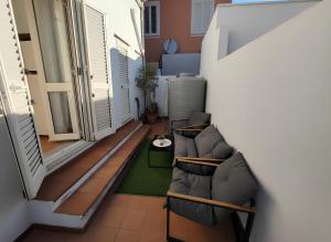 a living room with a couch and a table at La casa del Villaggio in Torre Faro