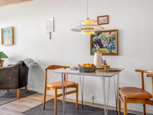 a dining room with a table and chairs at Apartment Didrik - 2km from the sea by Interhome in Skagen