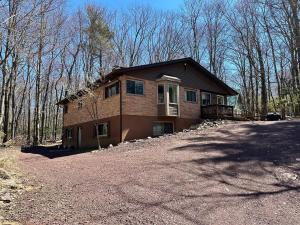 a house on a hill in the woods at Iron Hill in Lake Harmony