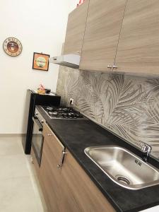 a kitchen with a sink and a counter top at Casetta la Bruna in Naples