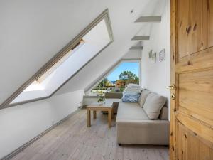 a living room with a couch and a table at Holiday Home Paale - 208m from the sea by Interhome in Læsø +21 photos