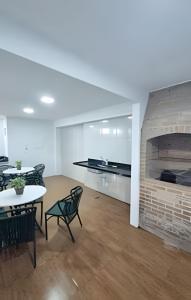 a living room with a fireplace and a table and chairs at Villa do Porto Resindece in Porto De Galinhas +255 photos
