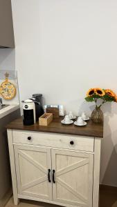 a white cabinet with a wooden counter top in a kitchen at La Vigna 1803 in Casa Gagliano