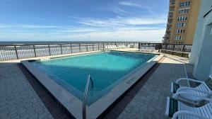 a swimming pool with a view of the ocean at Top-floor ocean view condo with a private balcony and beachfront pool in Edgewater