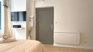 a bedroom with a door in the corner of a room at Le Doré Central WiFi in Thoissey