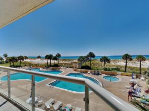a view of the pool and beach from the balcony of a resort at Emerald Isle #106 in Pensacola Beach