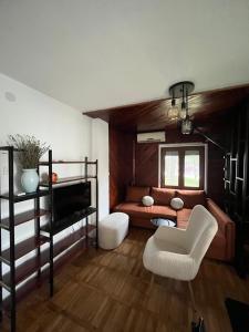 a living room with a couch and a chair at Vila Lika in Zlatibor