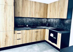 Η κουζίνα ή μικρή κουζίνα στο Nowoczesny Apartament +3 φωτογραφίες