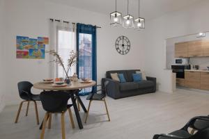 a living room with a table and a couch at Affittacamere La Violica in Villacidro