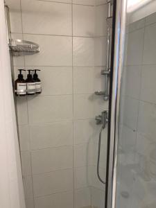 a bathroom with a shower with a glass door at Sol Stay Seoul Hongdae in Seoul