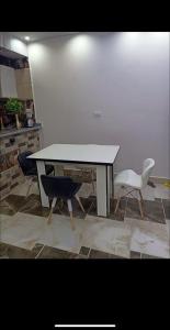 a table with two chairs and a white table and chairs at Dream Apartment 4 in Hurghada