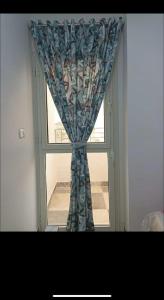 a window with a curtain in a room at Dream Apartment 4 in Hurghada