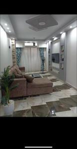 a living room with a couch and a tv at Dream Apartment 4 in Hurghada