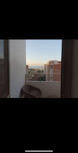 a bathroom with a toilet and a view of a city at Dream Apartment 4 in Hurghada