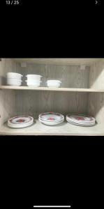 a shelf with four plates and bowls on it at Dream Apartment 4 in Hurghada +6 photos