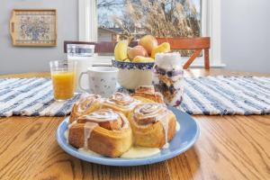 a plate of pastries on a table with a bowl of fruit at True Bed - and Breakfast! - made fresh by Grandma in Frankenmuth