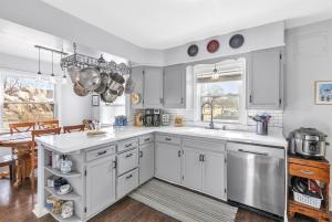 a kitchen with white cabinets and a sink at True Bed - and Breakfast! - made fresh by Grandma in Frankenmuth