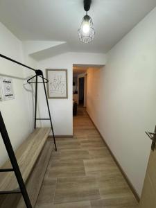 a hallway with a staircase and a light fixture at Appartement 1 chambre in Tulle