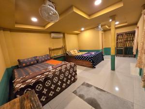 a room with two beds and a couch in it at Family Guesthouse and Hostel in Koh Rong Island +87 photos