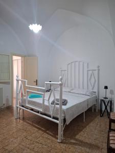 a bedroom with a white bed in a room at Casa Teresina in Cannole