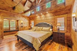 a bedroom with a bed in a room with wooden walls at The Lake Cabin in Santaluca