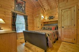 a bedroom with a bed in a log cabin at Lady of the Lake in Santaluca