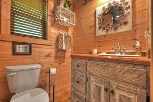 a bathroom with a toilet and a sink at Lord of the Lake in Santaluca +39 photos