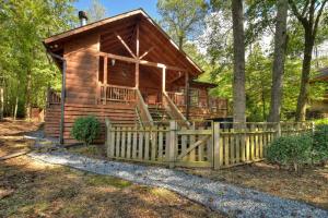 a log cabin in the woods with a wooden fence at Lord of the Lake in Santaluca